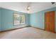 Bright bedroom with a ceiling fan, carpeted floor, and a window view at 239 Berry Rd, Mcdonough, GA 30252