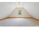 Finished bonus room with natural lighting from large window and neutral carpet at 239 Berry Rd, Mcdonough, GA 30252