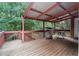 Enjoy outdoor living on this covered deck featuring a grill and a relaxing chair at 239 Berry Rd, Mcdonough, GA 30252