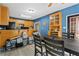 Dining area with long table and view into the kitchen with bar seating at 239 Berry Rd, Mcdonough, GA 30252