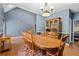 Spacious dining room with an elegant chandelier, hardwood floors, and a large table perfect for gatherings at 239 Berry Rd, Mcdonough, GA 30252