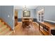 Traditional dining room featuring hardwood floors, wood furniture, chandelier, and classic two-tone paint scheme at 239 Berry Rd, Mcdonough, GA 30252