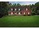 Charming two-story home with a well-manicured lawn and inviting front porch at 239 Berry Rd, Mcdonough, GA 30252