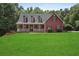 Charming two-story home with a well-manicured lawn and inviting front porch at 239 Berry Rd, Mcdonough, GA 30252