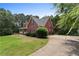 Red home with a spacious yard, mature landscaping, and inviting front porch at 239 Berry Rd, Mcdonough, GA 30252