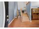Inviting foyer featuring hardwood floors, tall ceilings, staircase to the second floor, and traditional furnishings at 239 Berry Rd, Mcdonough, GA 30252
