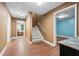 Hallway with wood floors leading to stairs, sitting room, and rooms with doors at 239 Berry Rd, Mcdonough, GA 30252