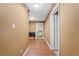 Hallway with hard wood floors leading to laundry room and rooms with doors at 239 Berry Rd, Mcdonough, GA 30252