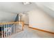Upstairs hallway with neutral paint, carpet, and wood banister at 239 Berry Rd, Mcdonough, GA 30252