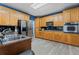 Kitchen with stainless steel appliances, wooden cabinets, and modern countertops at 239 Berry Rd, Mcdonough, GA 30252