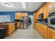 Kitchen with stainless steel appliances, wooden cabinets, and bar seating at 239 Berry Rd, Mcdonough, GA 30252