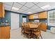 An open-concept kitchen and dining room area with bright light and wood accents throughout at 239 Berry Rd, Mcdonough, GA 30252