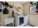 Laundry room with washer, dryer, utility sink, and shelving for storage at 239 Berry Rd, Mcdonough, GA 30252