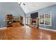 Spacious living room with fireplace, hardwood flooring, and backyard views at 239 Berry Rd, Mcdonough, GA 30252