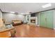 Cozy living room featuring a fireplace, comfortable seating, and wood flooring at 239 Berry Rd, Mcdonough, GA 30252