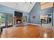 Open living room with fireplace, hardwood flooring, and open access to kitchen at 239 Berry Rd, Mcdonough, GA 30252