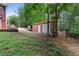 Backyard shed with a concrete path for easy access, useful for storage and hobbies at 239 Berry Rd, Mcdonough, GA 30252