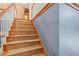 View of unfinished wood staircase with white railings and wooden trim detail leading to the second floor at 239 Berry Rd, Mcdonough, GA 30252