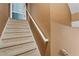 Carpeted stairs with white handrail going to the second floor of the home at 239 Berry Rd, Mcdonough, GA 30252