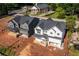 An aerial perspective of two new homes with gray and white exteriors, set against the backdrop of the town at 272 1St Ave, Avondale Estates, GA 30002