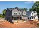 A modern two-story home showcases a gray exterior, complementing its newly constructed neighbor at 272 1St Ave, Avondale Estates, GA 30002