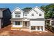 Charming two-story home with white siding, black framed windows, and a welcoming front porch at 278 1St Ave, Avondale Estates, GA 30002