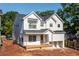 Charming two-story home with white siding, black framed windows, and a welcoming front porch at 278 1St Ave, Avondale Estates, GA 30002