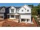 Charming two-story home with white siding, black framed windows, and a welcoming front porch at 278 1St Ave, Avondale Estates, GA 30002