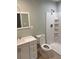 Clean bathroom featuring a white vanity, modern toilet, and a sleek shower with storage shelves at 2934 Union Grove Rd, Conyers, GA 30012