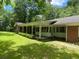 Inviting porch and well-maintained lawn complement this charming brick home at 2934 Union Grove Rd, Conyers, GA 30012