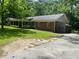 Charming one-story brick home with a spacious front yard and ample parking on a paved driveway at 2934 Union Grove Rd, Conyers, GA 30012