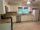 Well-lit kitchen with granite countertops, stainless steel appliances, and bright white cabinetry at 2934 Union Grove Rd, Conyers, GA 30012