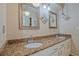 Bathroom featuring double sinks, granite countertops, and framed mirrors at 648 Cativo Sw Dr, Atlanta, GA 30311