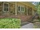 Inviting front porch with stone accents and brick stairs, adding character to the home's facade at 648 Cativo Sw Dr, Atlanta, GA 30311