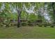 Well-maintained brick home featuring a meticulously landscaped front yard with vibrant flowers and mature trees at 648 Cativo Sw Dr, Atlanta, GA 30311