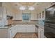 Well-lit kitchen features granite countertops, stainless steel appliances, and ample white cabinetry at 648 Cativo Sw Dr, Atlanta, GA 30311
