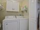 White washer and dryer with cabinets at 648 Cativo Sw Dr, Atlanta, GA 30311