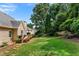 Serene backyard featuring a wooden deck, green lawn, and mature trees, creating a peaceful outdoor setting at 1377 Downington Nw Ln, Acworth, GA 30101