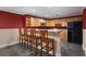 Finished basement bar area with wooden cabinets, a built-in wine rack, and bar stool seating at 1377 Downington Nw Ln, Acworth, GA 30101