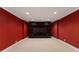 Finished basement rec room featuring a large entertainment center against deep red walls at 1377 Downington Nw Ln, Acworth, GA 30101