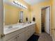 Yellow bathroom with double sink vanity, large mirror, and adjacent toilet and shower room at 1377 Downington Nw Ln, Acworth, GA 30101