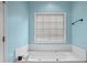 Bathroom with a soaking tub and tile surround at 1377 Downington Nw Ln, Acworth, GA 30101
