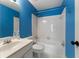 Bright blue bathroom with a toilet, tub, and vanity with sink at 1377 Downington Nw Ln, Acworth, GA 30101