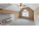 Lofted beige bedroom featuring a window, door, and ceiling fan with light at 1377 Downington Nw Ln, Acworth, GA 30101