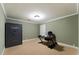 This room features neutral carpet and trim, a safe, and a desk with chair at 1377 Downington Nw Ln, Acworth, GA 30101