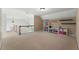 Spacious bonus room featuring neutral carpet, storage shelves, and modern lighting at 1377 Downington Nw Ln, Acworth, GA 30101