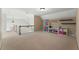 Large bonus room with neutral carpet, storage, and access to the lower level at 1377 Downington Nw Ln, Acworth, GA 30101