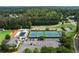 Aerial view of community featuring pool, tennis courts, playground, and clubhouse with parking lot at 1377 Downington Nw Ln, Acworth, GA 30101