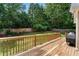 Wooden deck area with a grill overlooking a lush, fenced backyard, perfect for outdoor entertaining at 1377 Downington Nw Ln, Acworth, GA 30101