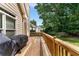 Back deck featuring a grill, offering a relaxing outdoor space with views of the green, tree-lined yard at 1377 Downington Nw Ln, Acworth, GA 30101